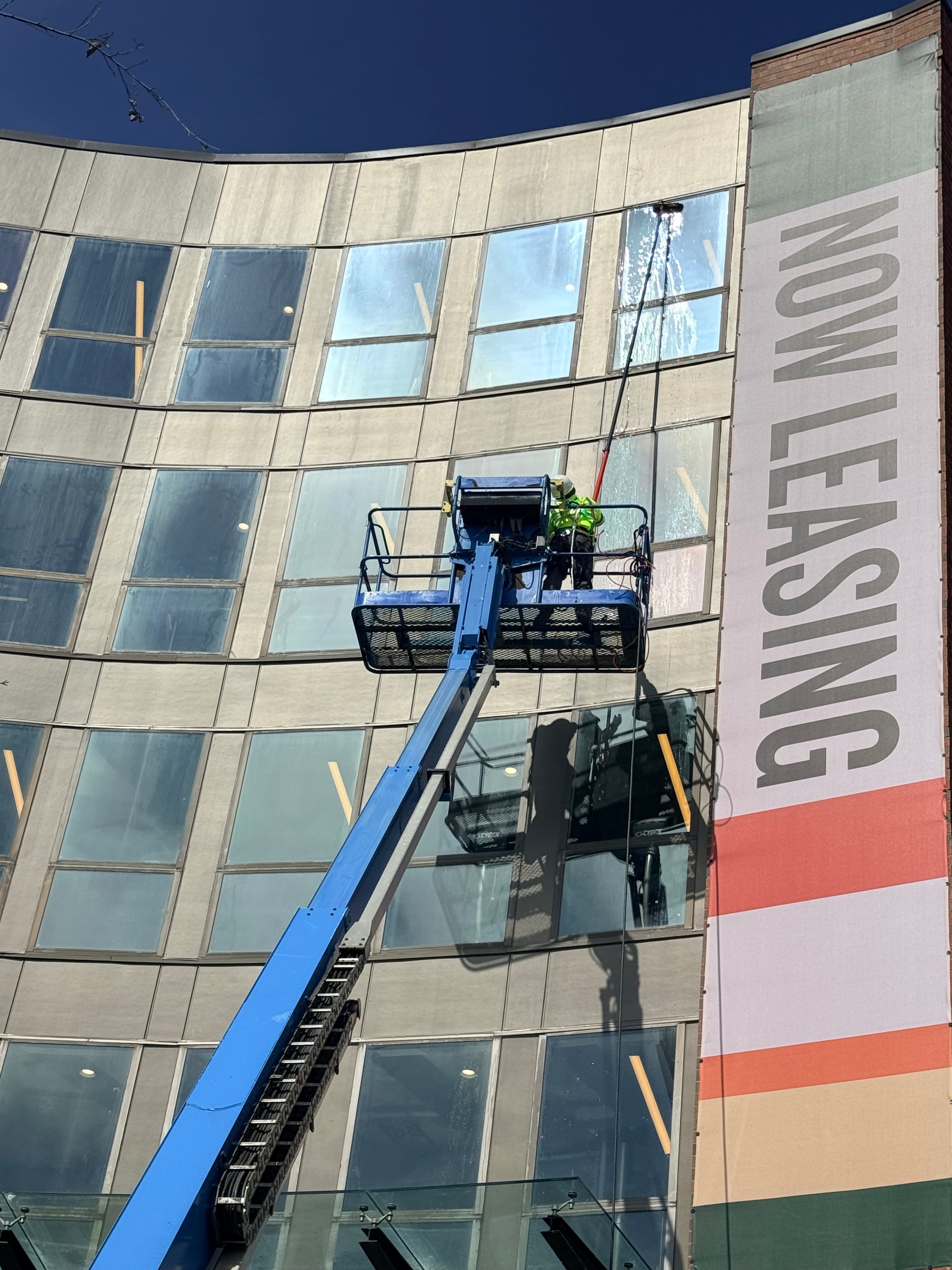 Boom lift window cleaning on commercial building