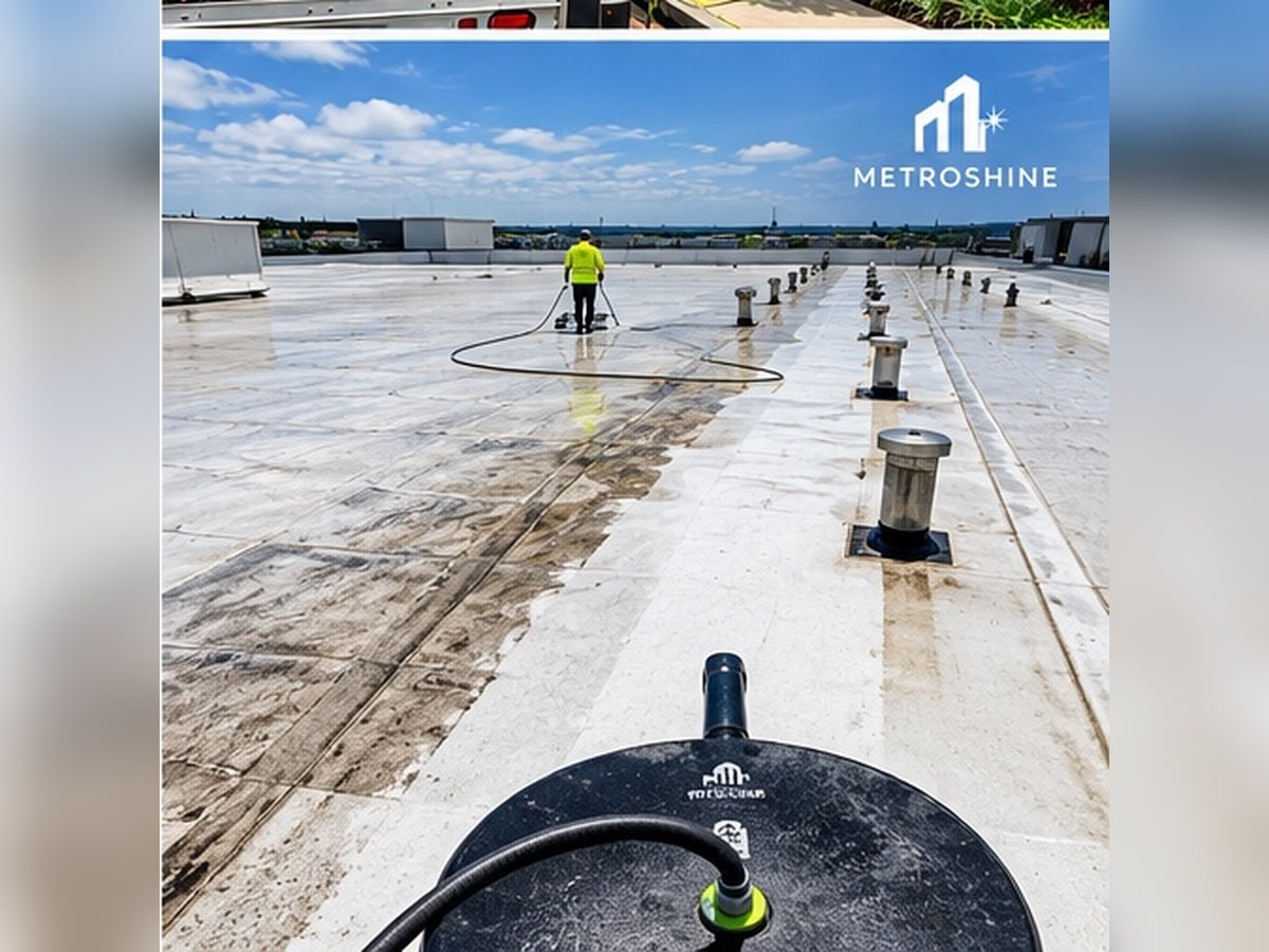 Worker cleaning commercial flat roof surface